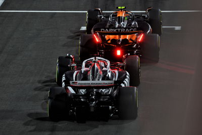 McLaren and Haas leave the pit lane